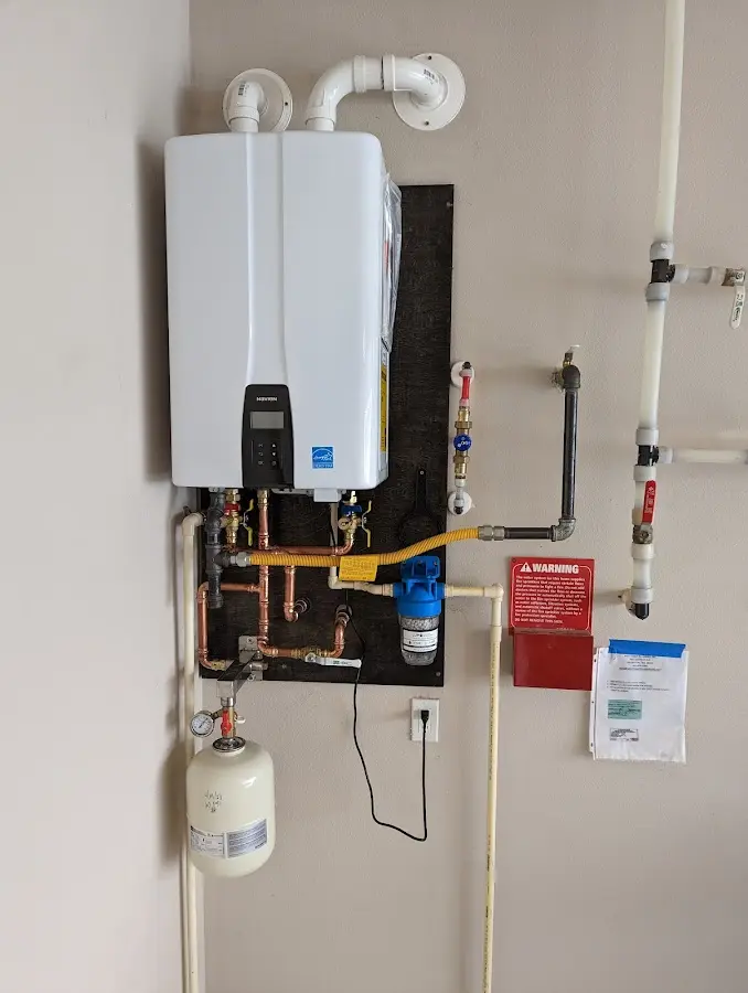 Professional plumber installing copper piping in a Lake Zurich home